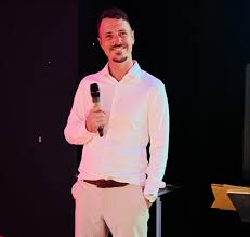 DJ Craig A holding a microphone on stage